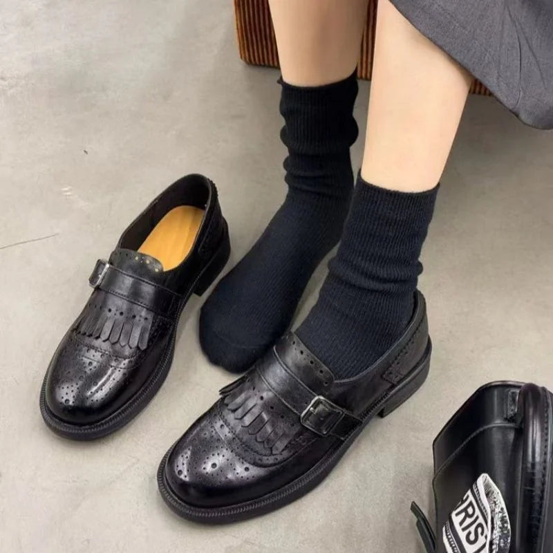 Black single strap with buckle Women's Brogue Loafers with Fringed Kiltie & Cushioned Footbed - Flat Lay With Socks
