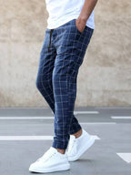 Men's Windowpane Plaid Trousers with Drawstring Waist & Tapered Fit - Side Walking Pose