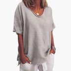 Grey Women's Oversized V-Neck Short Sleeve Blouse with Curved Hem - Studio Pose