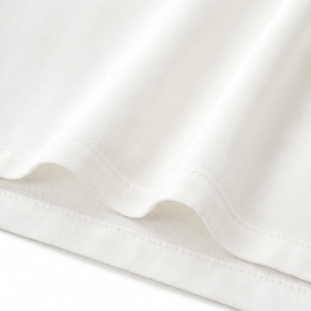 White Women's Oversized Ruffle Blouse with V-Neck & Three-Quarter Sleeves — Nell - Hem Detail