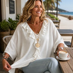 White Women's Oversized Ruffle Blouse with V-Neck & Three-Quarter Sleeves — Nell - Seated Outdoor